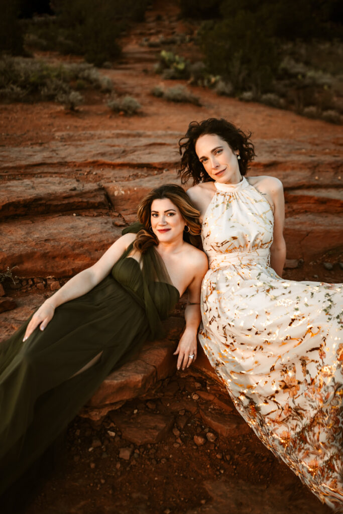 Two women friends laying on the red rocks of sedona.