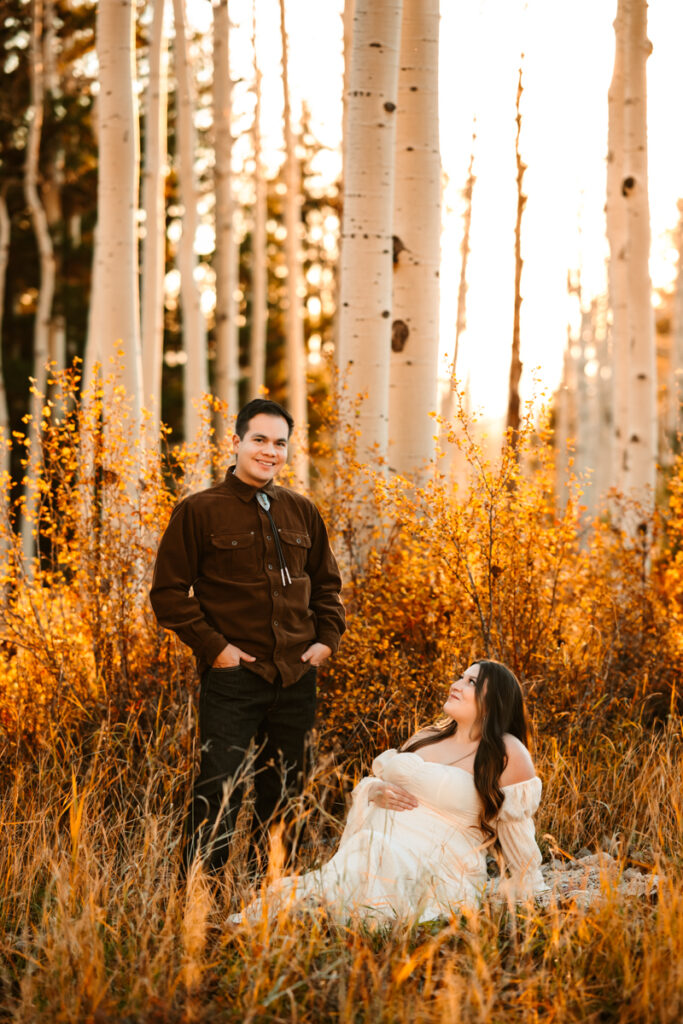 A man in a tie standing with his wife in the aspens in Arizona by annie bee photography.