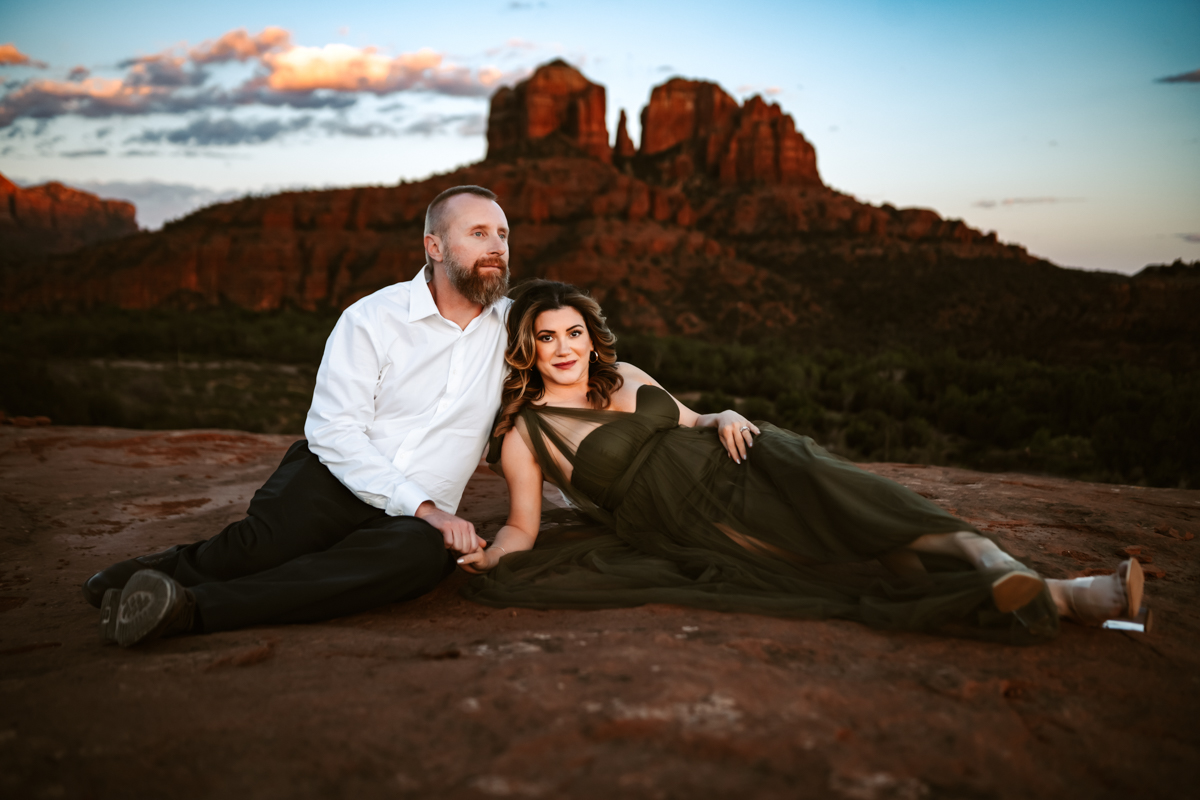 couple in front of cathedral rock in sedona at a sunset portrait session.