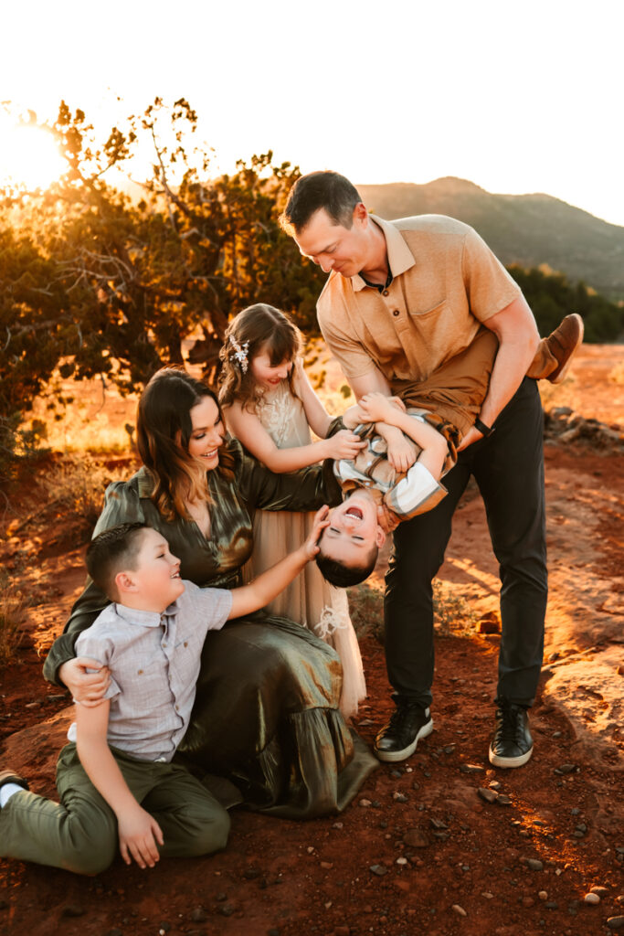 Family hugging at sunset in the red rocks of sedona by annie bee photography.