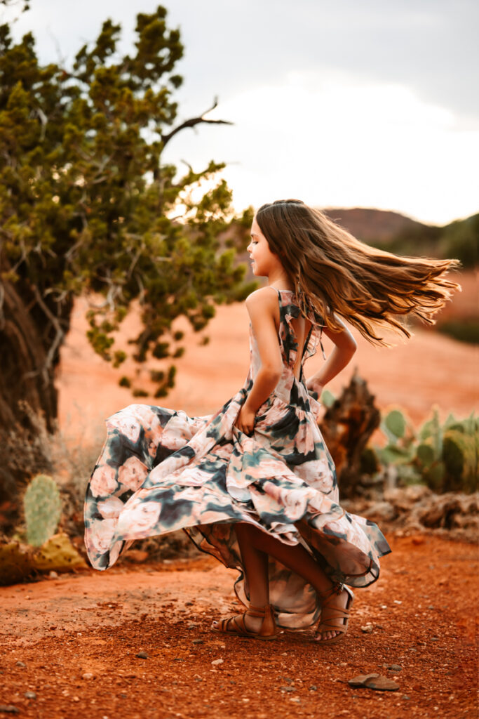 Girl twirling in a joyfolie maxie dress at secret slick rock in sedona by annie bee photography.