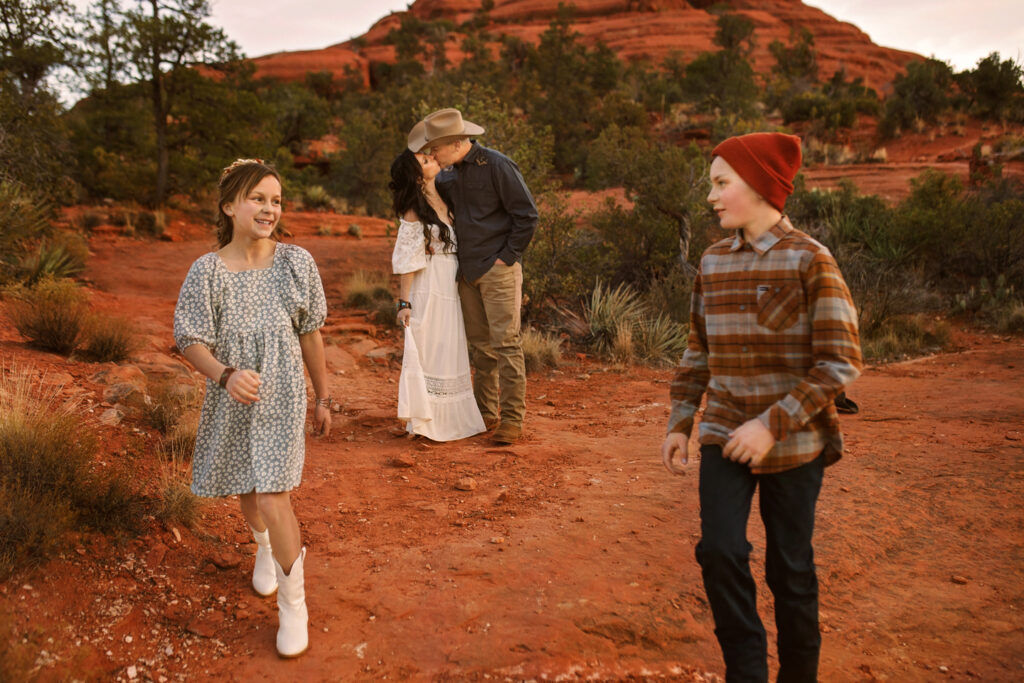 Owner of Annie Bee Photographer and her family exploring the red rocks of Bell Rock in Sedona at sunset.