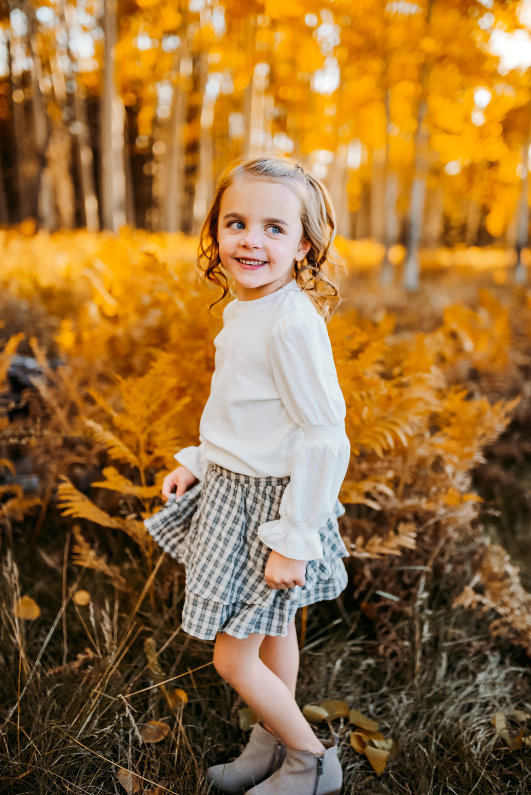 Best dressed child in a Gap outfit twirling her skirt in the aspen tress of Flagstaff.