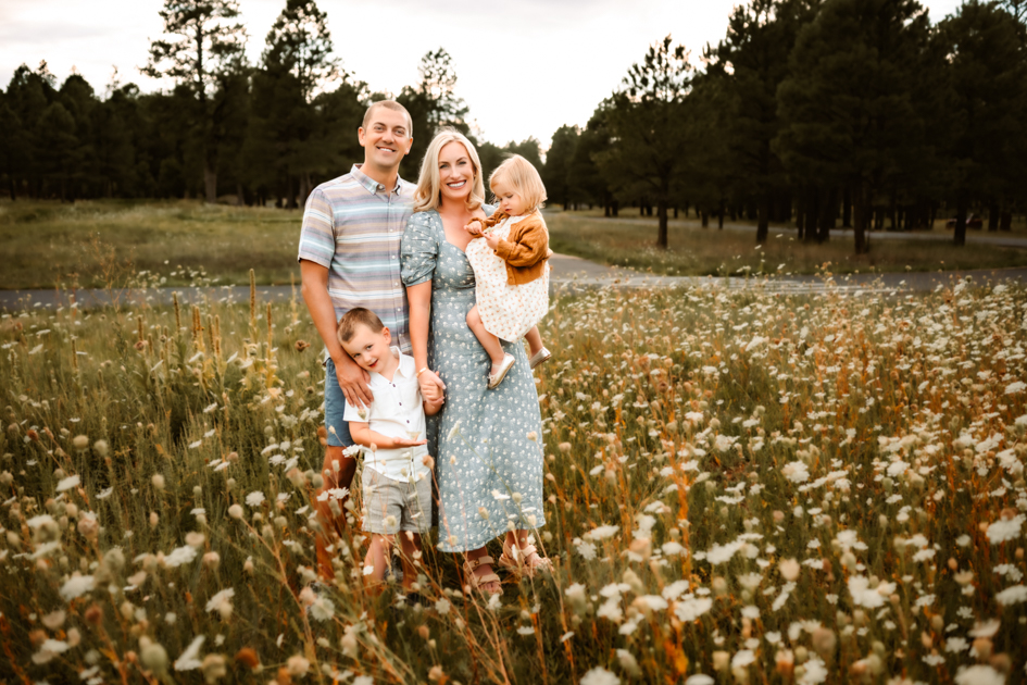 Flagstaff family poses for a portrait in a field of wildflowers at Forest Highlands golf club.