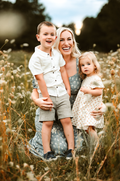 Mother and son smiling at each other in a field of wildflowers in Flagstaff, Arizona at Forest Highlands Country Club.