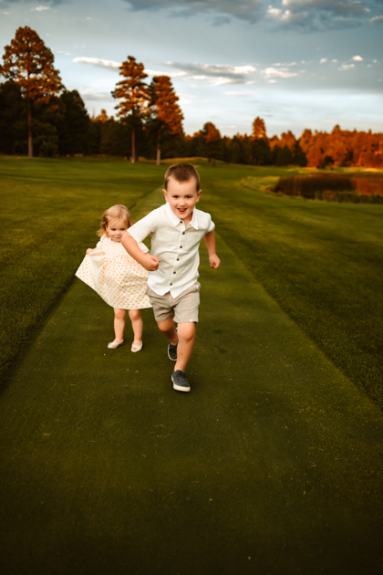 Kids running on a golf course at Forest Highlands golf club in Flagstaff.