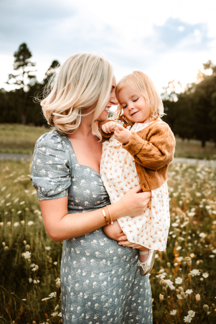 Mother and daughter kissing during golden hour at Forest Highlands Golf Club in Flagstaff.