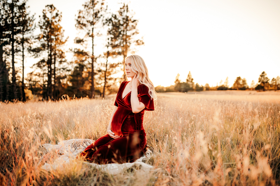 Expecting mom in a velvet dress at Buffalo Park in Flagstaff.