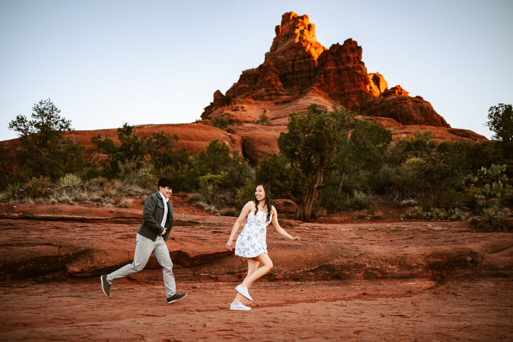 Bell Rock at sunset with couple chasing each other.