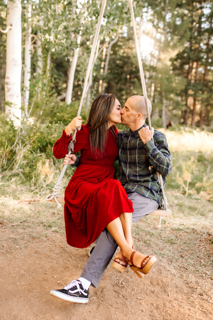 Couple swinging on a swing together in Flagstaff, Arizona kissing by Annie Bee Photography.