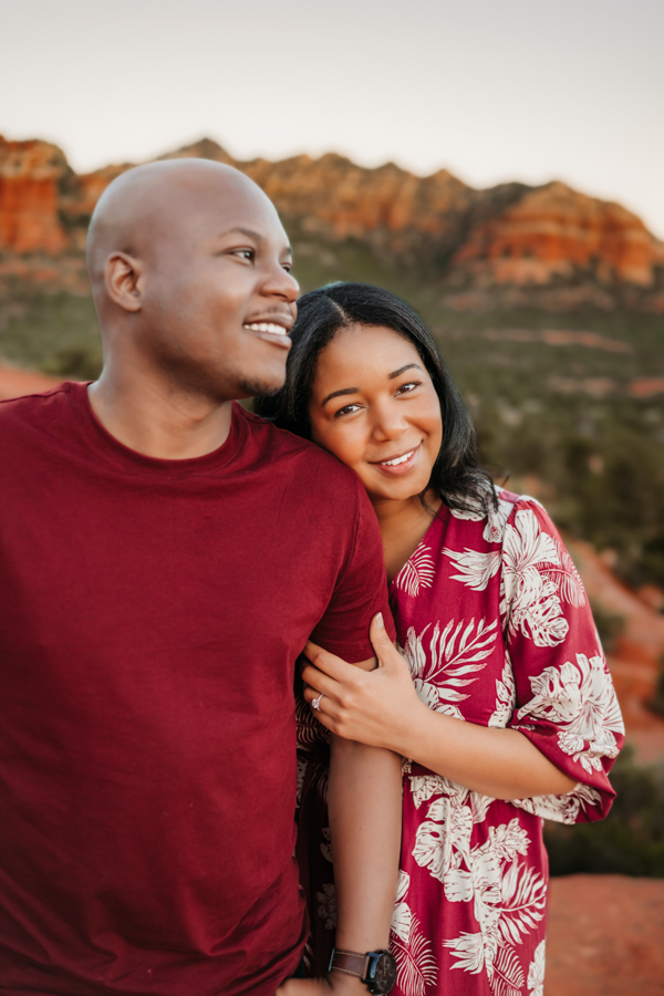 Couple smiling at sunrise in Sedona enjoying the view.