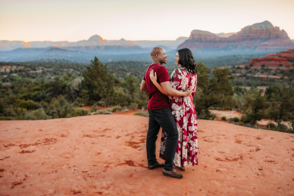 Couple at Bell Rock in Sedona enjoying the sunrise by Annie Bee Photography.