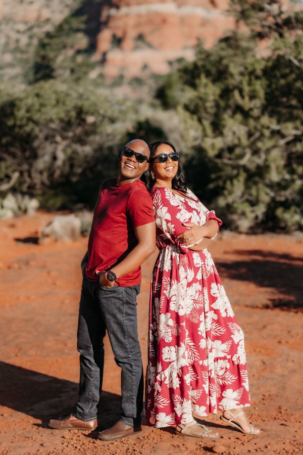 Couple wearing sunglasses laughing at Courthouse Butte in Sedona by Annie Bee Photography