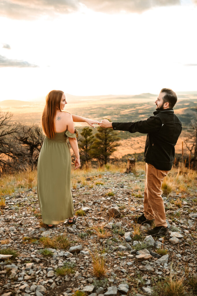 Couple dancing at the top of Slate Mountain in Flagstaff, Arizona after her boyfriend proposed to her by Annie Bee photography.