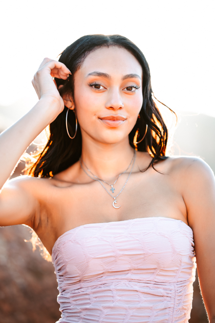 Arizona senior graduate smiling in the golden hour sunlight in Flagstaff by Annie Bee Photography.