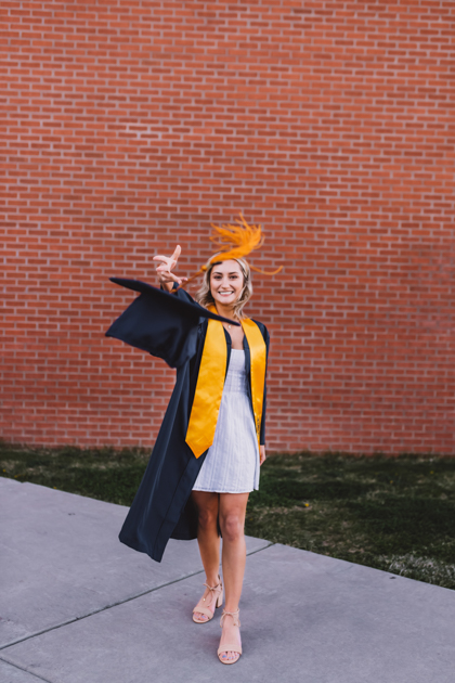 AZ senior graduate throwing cap into the air in Flagstaff by Annie Bee Photography.