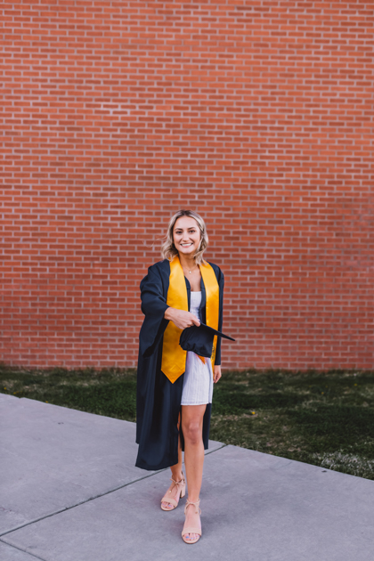 Northern Arizona University senior wearing her cap and gown by Annie Bee Photography.