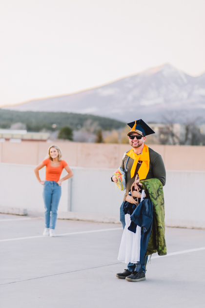 NAU senior graduate with cap and gown dancing by Annie Bee Photography.