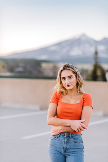 NAU graduate standing in front of Arizona Snowbowl in Flagstaff by Annie Bee photography