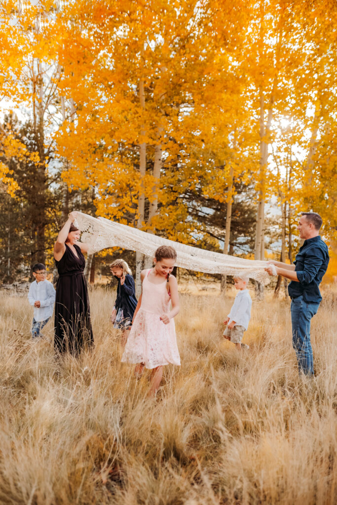 Family playing with their kids during arizona mini sessions at aspen corner in Arizona.