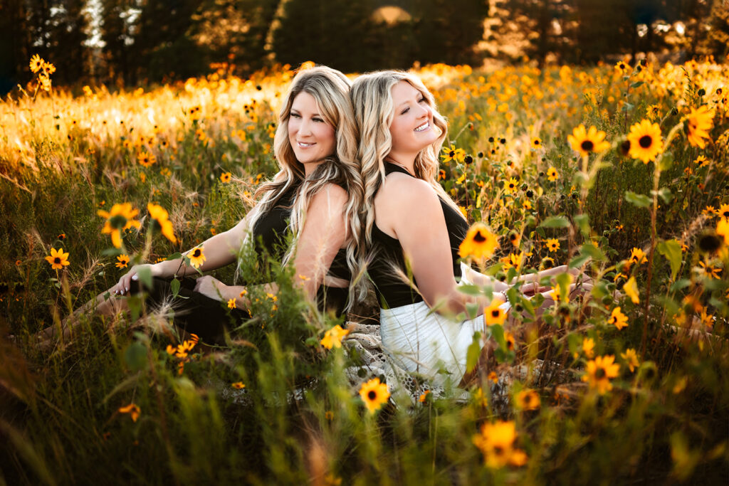 Flagstaff sunflowers at Buffalo Park of mom and daughter laughing in a field dressed in black and white outfits.