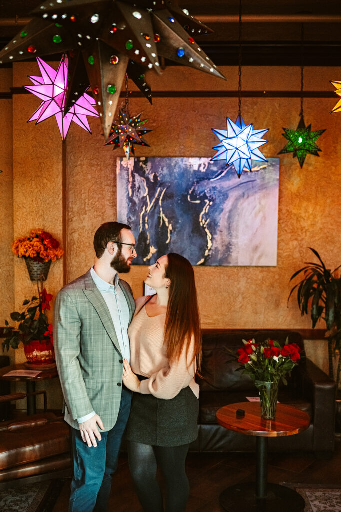 Man proposing to his girlfriend with a ring and roses at hotel monte vista.