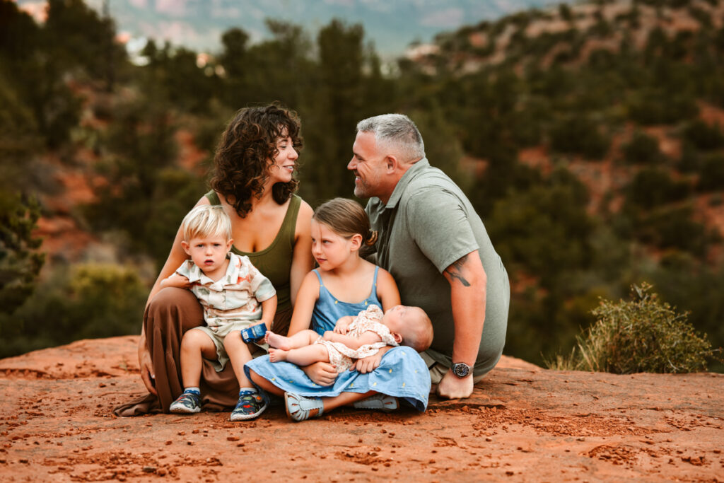 Family with children laughing together in the mountains of Sedona.