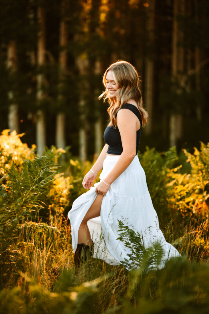 Girl in a long skirt walking through the ferns on Arizona Snowbowl.