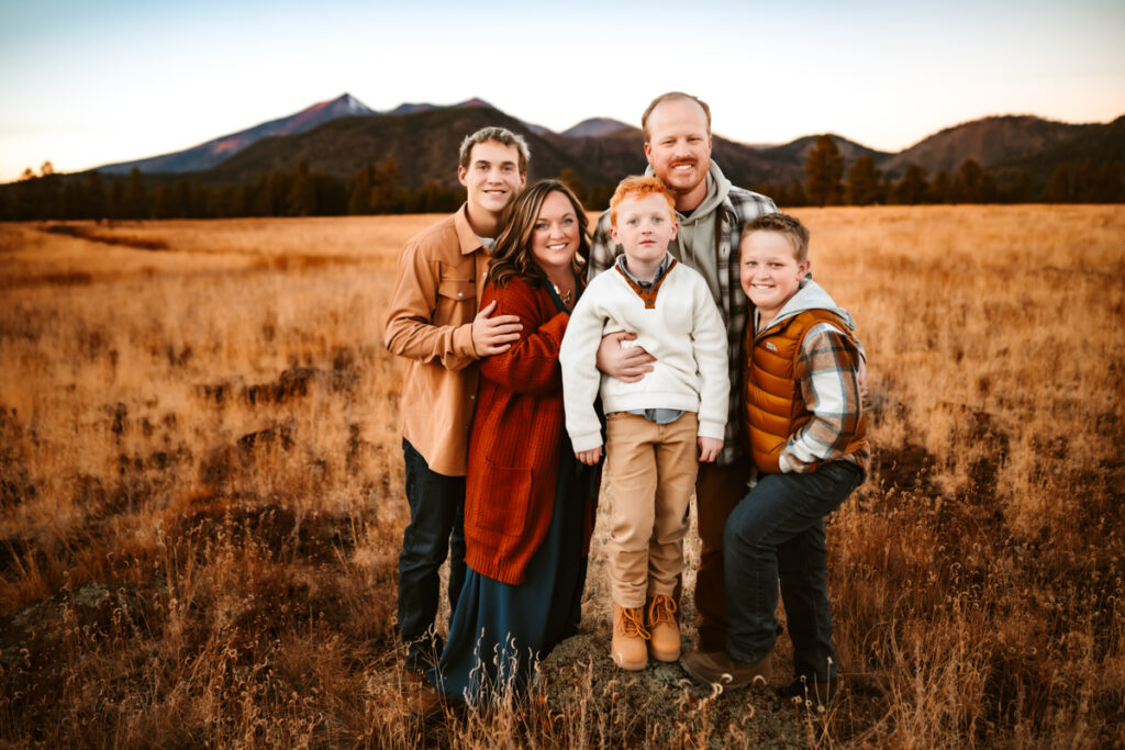 Family in front of mount humpreys in fall clothing by annie bee photography at the best Flagstaff photo locations