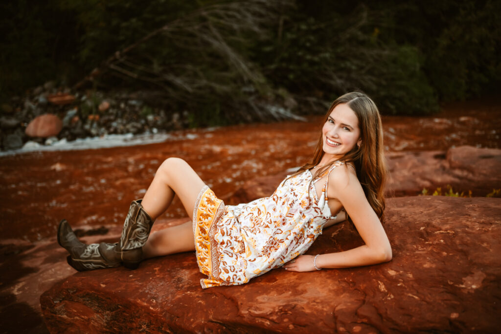 Senior girl smiling by oak creek canyon in sedona by annie bee photography