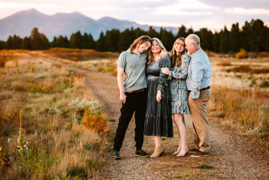 Family of four on a trail at kachina wetlands in front of mount humpreys by annie bee photography.