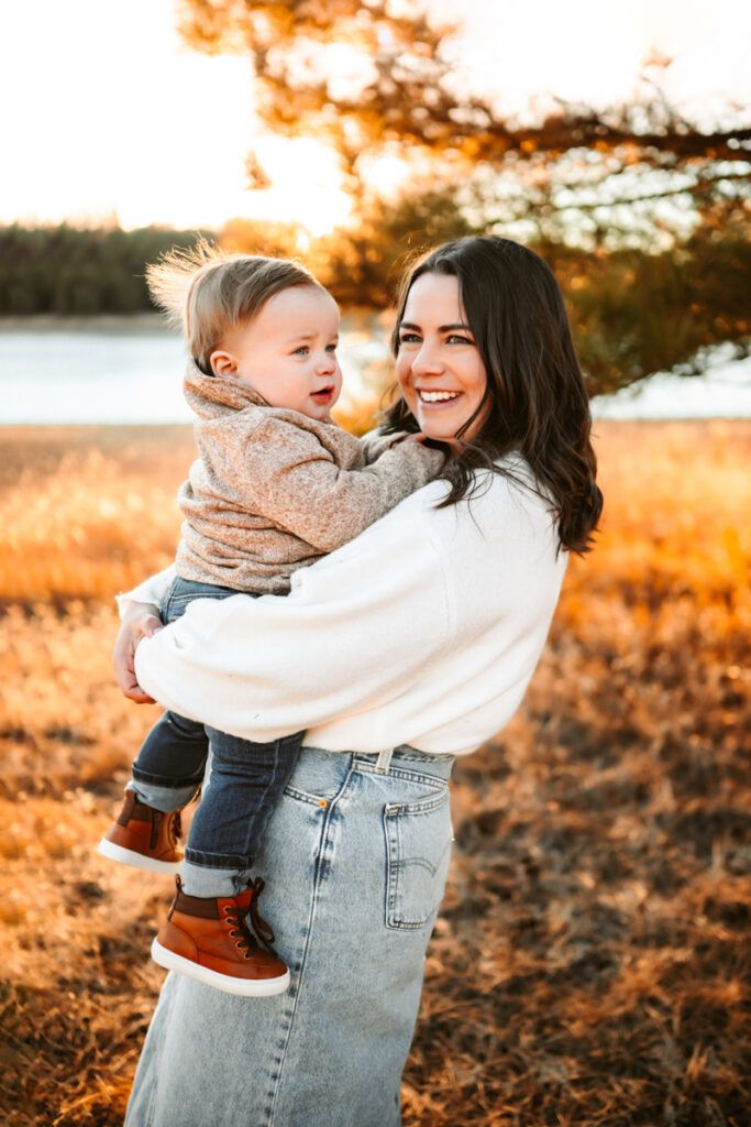 mother holding her toddler laughing at lake mary in flagstaff.