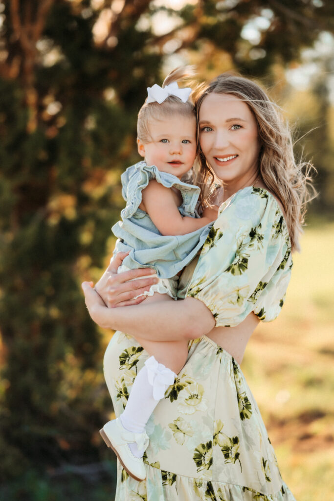 Mom and baby in matching dresses in the forest by annie bee photography.