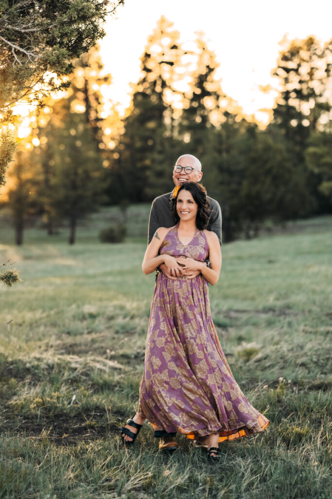 husband and wife laughing in the ponderosa pines in a free people dress by annie bee photography.