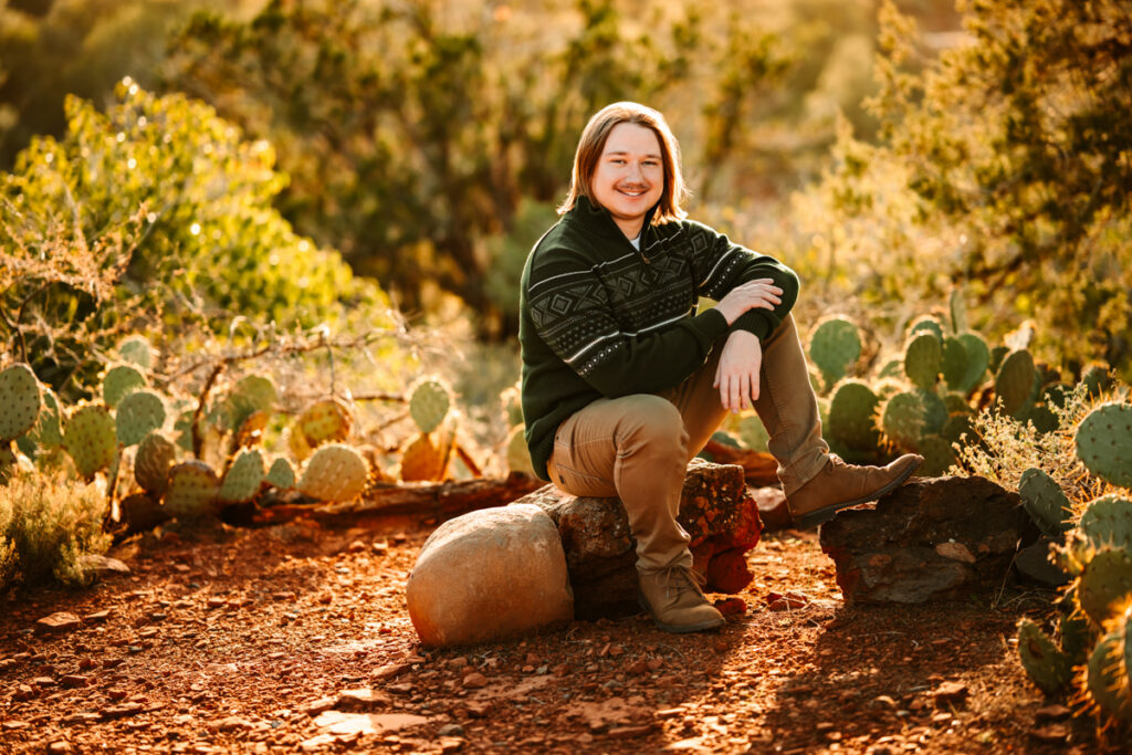 Man smiling with prickly pear cactus on a sedona trail.