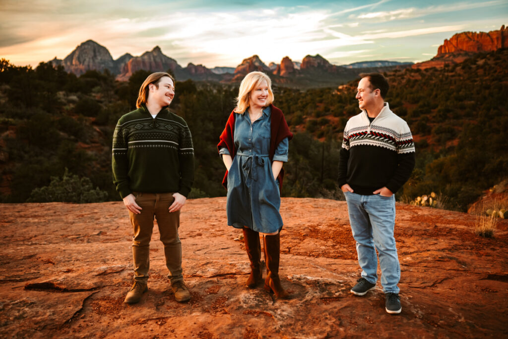 family at munds wagon trail looking at each other in the red rocks of sedona.