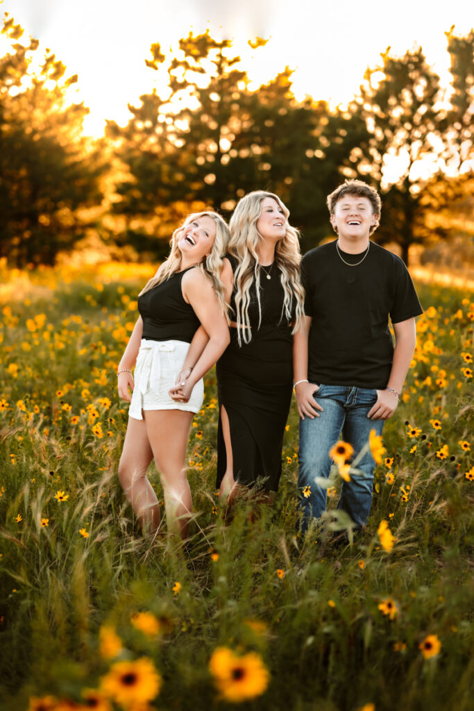 Mother with her kids laughing in a field of wildflowers in flagstaff.