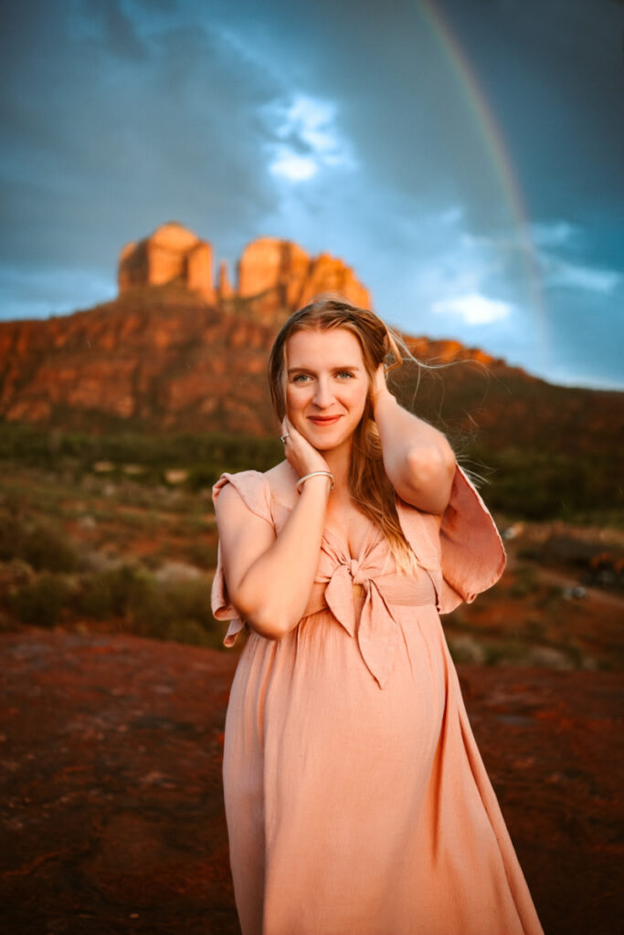 Maternity session with an expecting mom and a rainbow and Cathedral Rock.