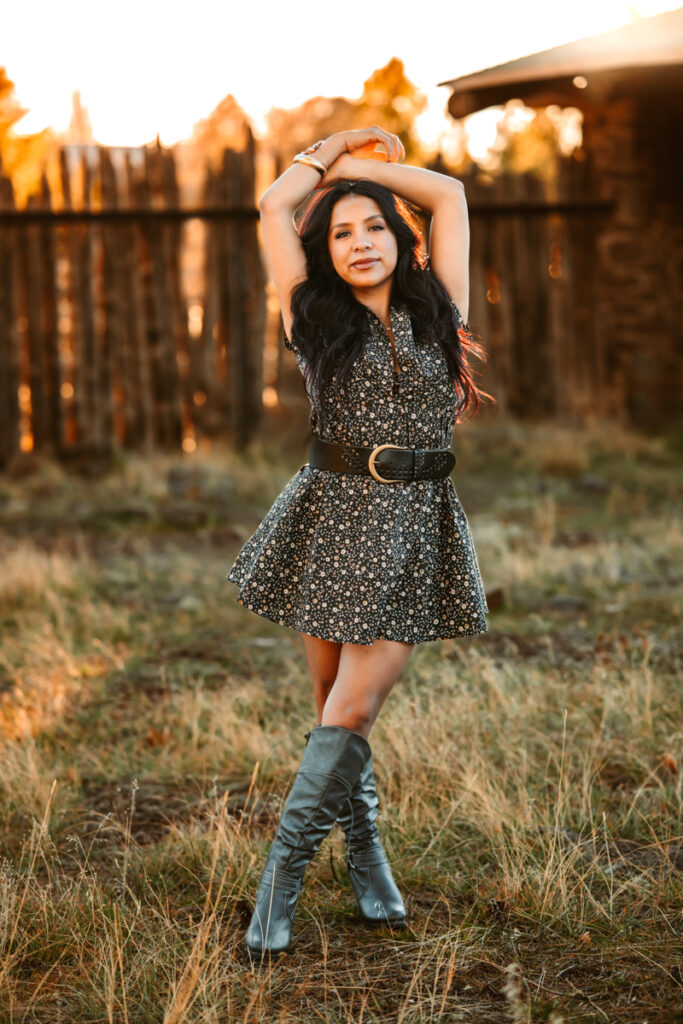 Hair stylist posing at buffalo park in knee high boots and a casual dress for her branding session in flagstaff.