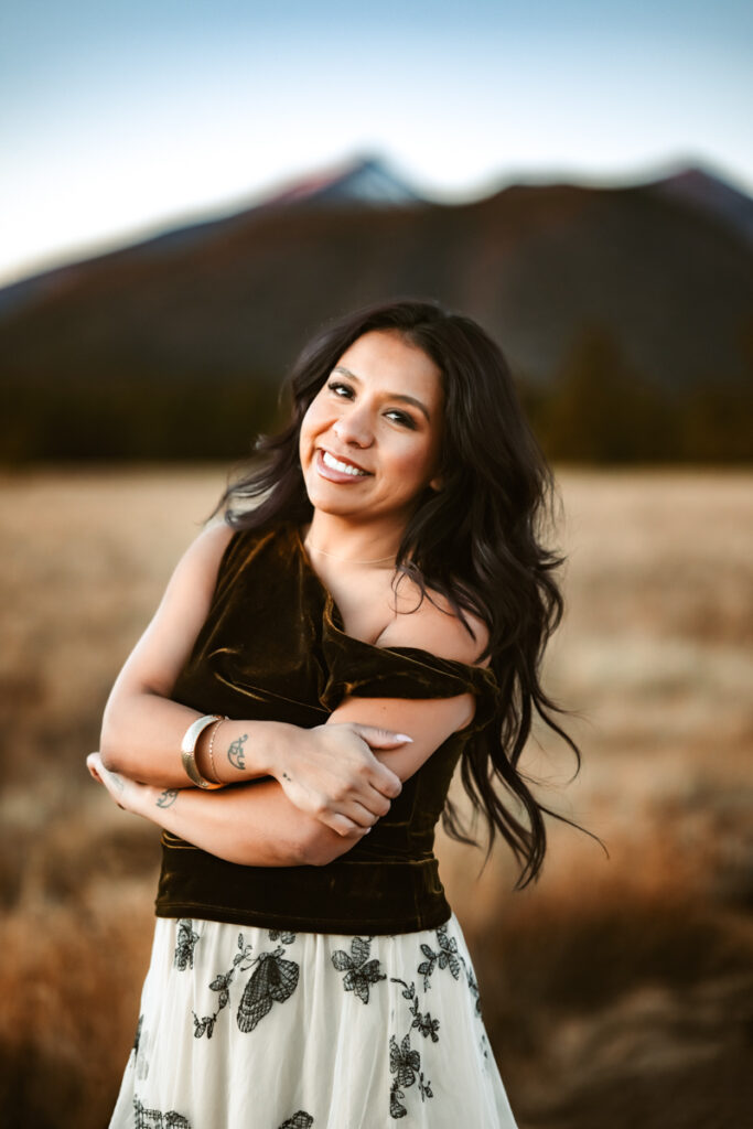 Hairstylist Carla Diaz smiling in front of arizona snowbowl.