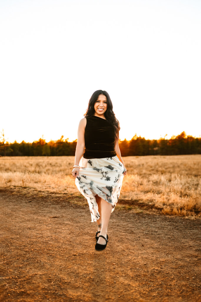 Hairstlist Carla Diaz walking in a tulle skirt.