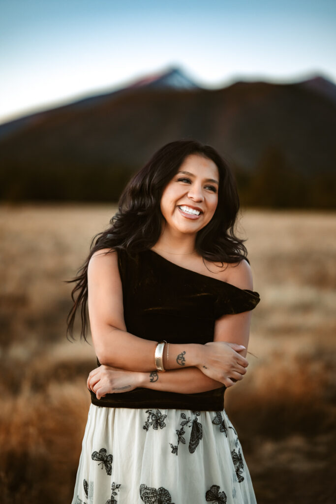 Flagstaff hair stylist Carla Diaz laughing in front of the San Fransisco Peaks by annie bee photography.