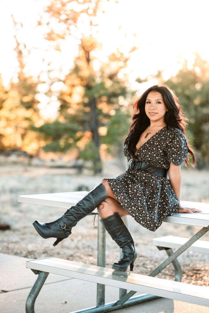 Woman posing on a picnic bench by annie bee photography.